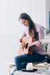 © stokkete - Girl playing guitar at home
