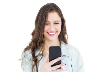 Smiling young woman using her smartphone