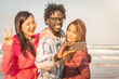 © Davide Angelini - group of multiracial people taking a selfie