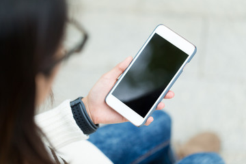 Woman usinf cellphone with blank screen