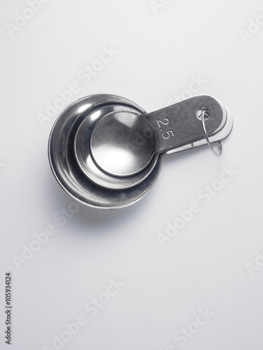 Fotografia, Obraz stainless steel measuring spoon on white background