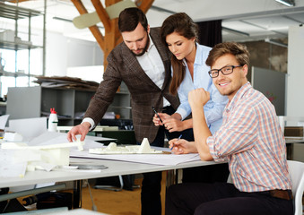 Confident team of engineers working together in a architect stud