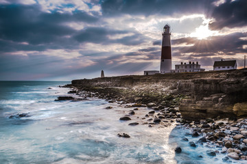 Dramatic sunset with iconic lighthouse on coast