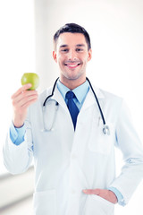 Wall Mural - male doctor with green apple