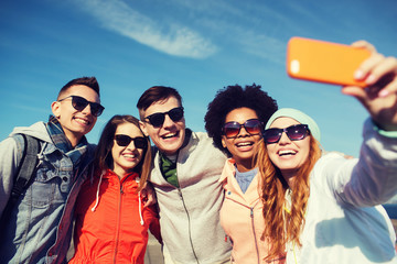 Sticker - smiling friends taking selfie with smartphone