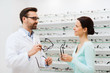 © Syda Productions - woman and optician showing glasses at optics store