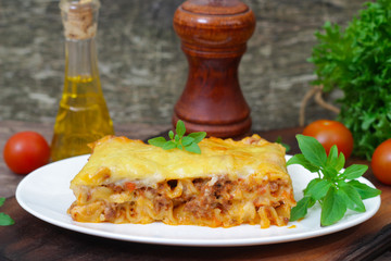 Wall Mural - Classic Lasagna with bolognese sauce on a wooden background. Italian food