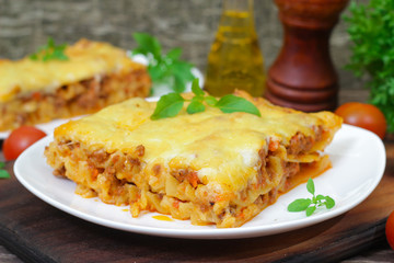 Wall Mural - Classic Lasagna with bolognese sauce on a wooden background. Italian food