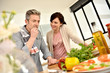 © goodluz - Middle-aged couple having fun cooking together