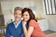 © goodluz - Portrait of middle-aged couple enjoying new home
