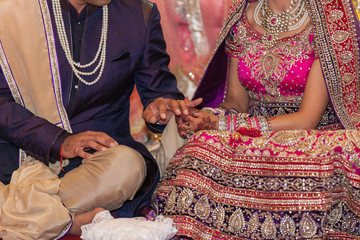 Indian bride and groom in a temple during wedding ceremony. 