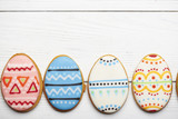 Fototapeta Desenie - Colorful easter cookies on blue wooden background