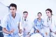 © WavebreakMediaMicro - Concerned doctors standing near patient on bed