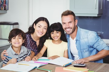 Wall Mural - Portrait of happy parents assisting children 