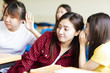 © Tom Wang - happy student girl gossiping in classroom