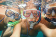 Underwater photo of a young people snorkeling at tropical ocean