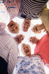 Wall Mural - Senior friends standing in circle