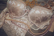 Sexy lace lingerie and pearls on a wooden board