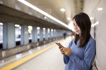 Poster - Woman use of mobile phone in train station