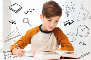 Wall Mural - student boy with book writing to notebook at home