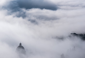 Naklejka na meble Church of Cortona immersed in fog in Tuscany - Italy