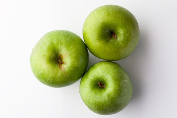 Wall Mural - Three green fresh ripe apple on white background directly from above