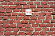 Red brick wall background with number 56