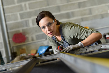 Metalworker woman in workshop