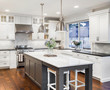 © bmak - Beautiful Kitchen in Luxury Home with Island, Hardwood Floors, and Stainless Steel Refrigerator