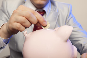 Businessman with pink piggy bank