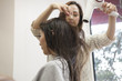 © Monet - Beautician is dry the hair of the woman in the dryer