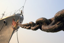 Fragment Of Prow Old Rusty Grey Military Ship With The Metallic Anchor Chain Diagonally