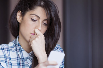 Portrait of young sad annoyed woman, receiving bad sms