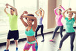 © Syda Productions - group of smiling people dancing in gym or studio