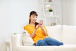 © Syda Productions - happy asian woman with smartphone at home