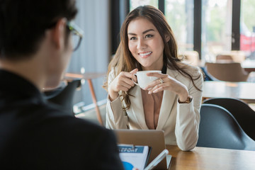 portrait of two business people discussing new project in coffee