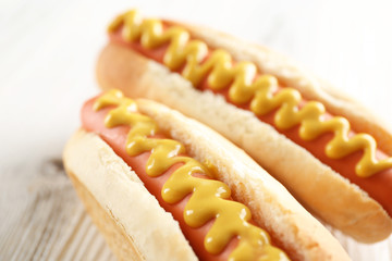 Two hot dogs on wooden background