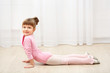© Africa Studio - Little cute girl in pink leotard making new ballet movement at dance studio