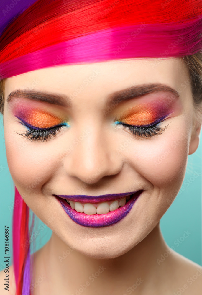 Beautiful girl with colorful makeup and hairstyle on blue background - obrazy, fototapety, plakaty 