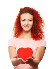 Poster - Red-haired young woman holding red heart, isolated on white