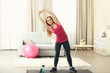 © Africa Studio - Young sportswoman doing exercises on a mat at home