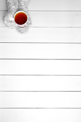 Poster - Female hands holding cup of hot drink, on wooden table background