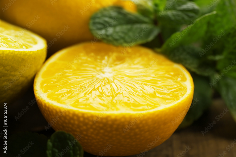 Sliced fresh lemon and lime with green leaves closeup