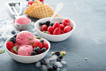 Raspberry ice cream in white bowl