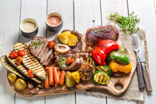 Grilled Vegetables And Steak With Herbs On White Table