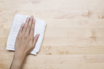 Cleaning table by woman hand