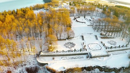 Wall Mural - Winter landscape. Aerial footage. Sunset. River and sea coast. Camera tilt up.