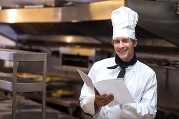 Handsome chef reading menu