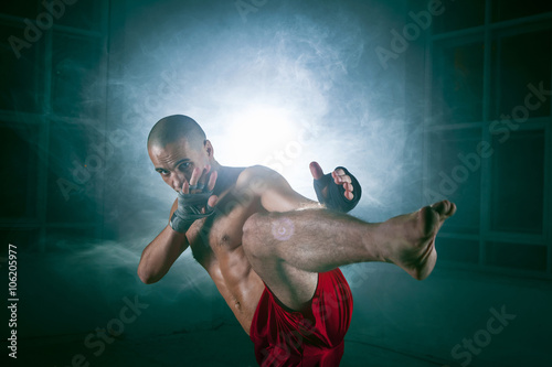 Ταπετσαρία τοιχογραφία The young man kickboxing in blue smoke
