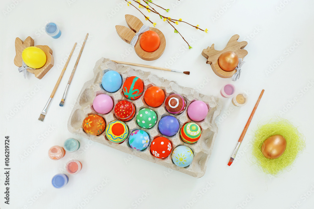 Colorful Easter eggs on white table, top view